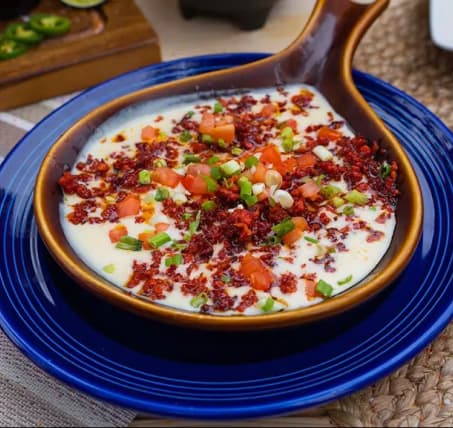 Queso fundido topped with pico de gallo