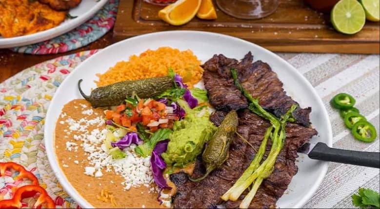 Steak fajitas plated with rice and vegetables